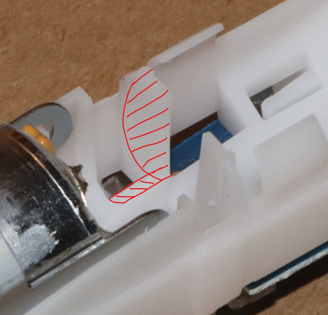 Plastic to remove for fitting longer battery to Triumph v2 (b)