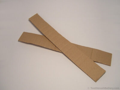 2-cardboard-strips-protect-toothbrush-handle-disassembly
